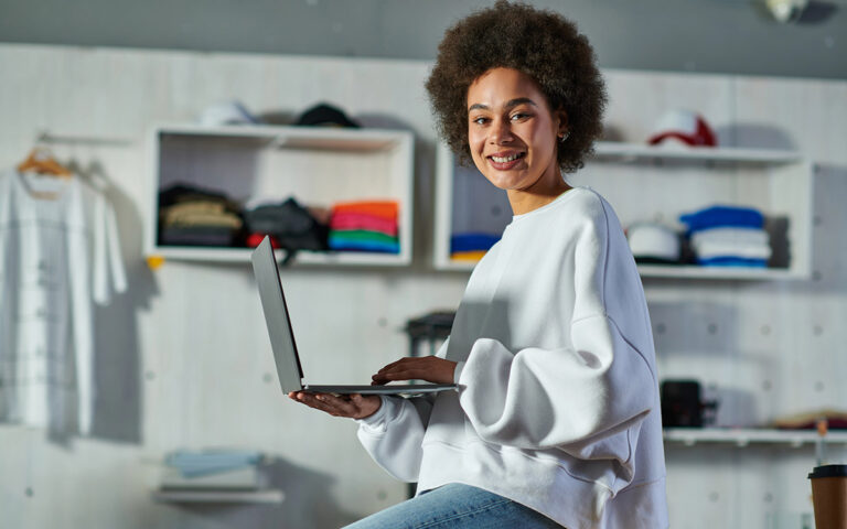 woman on her computer at her store